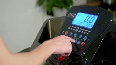 Hand of unrecognizable athlete adjusting treadmill workout program on digital 스톡 동영상 331206474