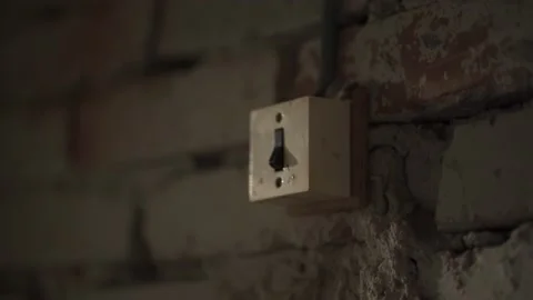 Hand of unrecognizable man presses the retro button of an old switch in darkness Stock Footage 155657772