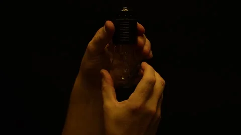 Hand unscrewing the light bulb from the socket, close-up Stock-Footage 263717761