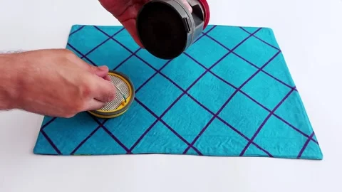 Hand Unsnaps Vacuum Filter on Blue Textile- Close-Up Repair Moment Video stock 313469745