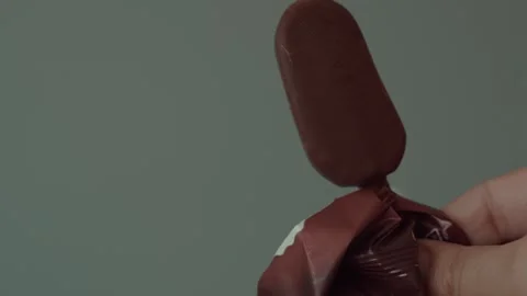 Hand Unwrapping Ice Cream in Plain Wrapper Stock Footage 337497570