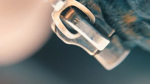 Hand unzipped and fasten golden colored metallic zipper on dark clothes. Macro Video stock 59794936