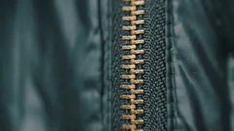 Hand unzipped and fasten golden colored metallic zipper on dark clothes. Macro Stock Footage 59795147