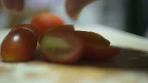 Hand use knife cut small baby tomatoes to cook uacamole mexican dipping appet Stock Footage 218362072