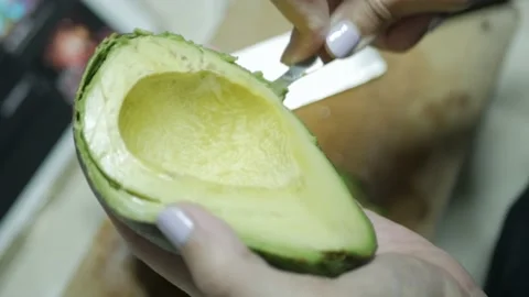 Hand use spoon to scoop fresh avocado to cook guacamole mexican dipping appet Stock Footage 220732976