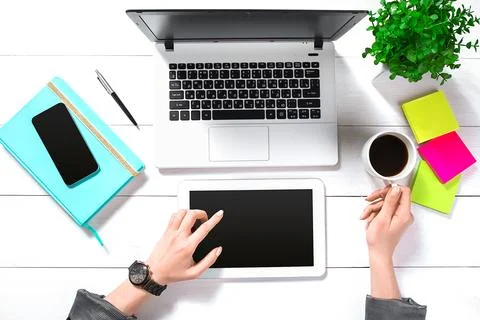 Hand use white tablet on desk table top view Stock Photos