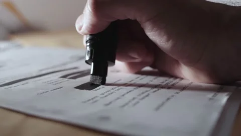 Hand uses black marker to redact censor or sanitize text before declassification Stock Footage 199977998