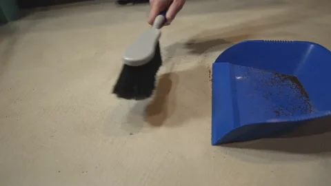 Hand uses dust pan to clean dirt1 Stock Footage 156223319