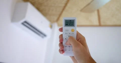 Hand uses remote activate air conditioner, lowering temperature button display Video stock 270401803