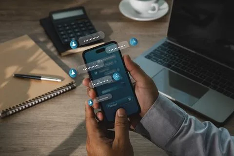 Hand uses smartphone with AI chatbot interface, floating message bubbles, p.. Stock Photos