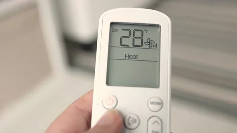 Hand using air conditioning remote control Stock Footage 235550589