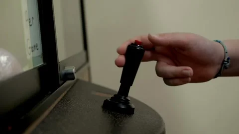 Hand Using Arcade Joystick with Red Button on Game Cabinet Close-Up Stock Footage 324805529
