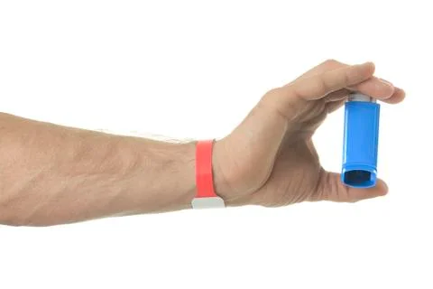 A hand using an asthma inhalator Stock Photos