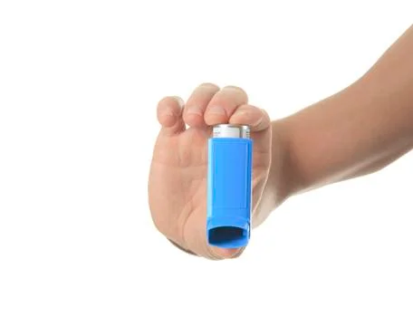 A hand using an asthma inhalator Stock Photos