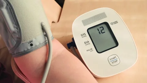 Hand using automatic tonometer for blood pressure checking. Stock Footage 326311542