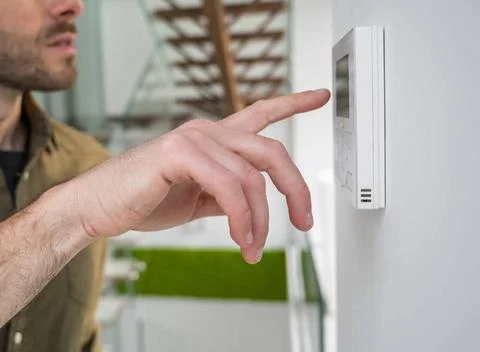 Hand using an automation screen in at home Hand using an automation screen... 스톡 사진