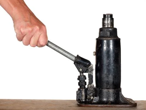 Hand using automobile hydraulic bottle jack Foto stock