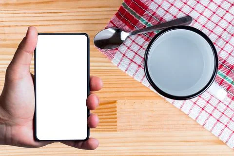 Hand using bezel less smart phone with blank screen. Stock Photos