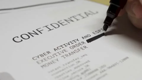 Hand using a black marker erases text lines from top secret document file Stock Footage 139681364