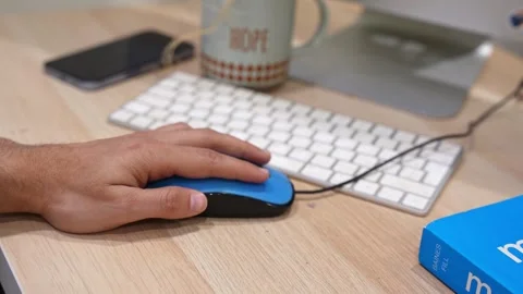 Hand Using Blue Computer Mouse on Modern Office Desk Workspace Видео 332793995