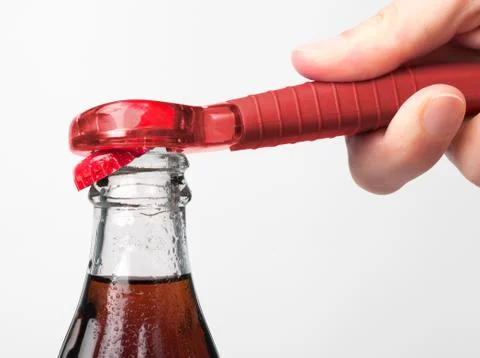 A hand using bottle opener to open the soda Stock Photos