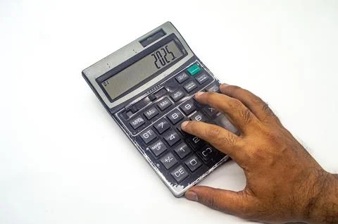 A hand using a calculator displaying the year 2025, symbolizing future fina.. Stock Photos