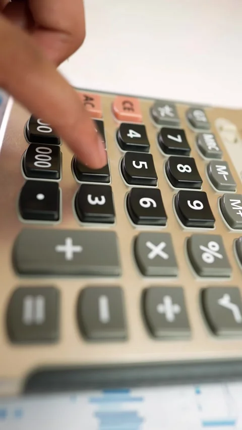 Hand Using Calculator on Financial Charts Stock Footage 320724956
