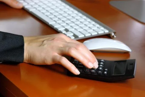 Hand using calculator Stock Photos