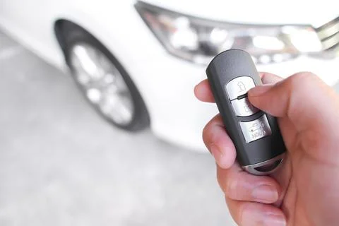Hand Using Car Key Fob to Lock or Unlock Stock Photos