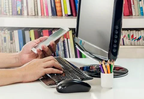 Hand using computer and smartphone Stock Photos