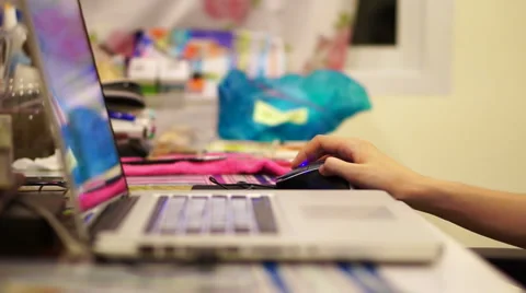 Hand using computer with colourful blur background Stock Footage 51217587