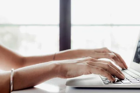 Hand using computer at home for working, e-learning and social network Stock Photos