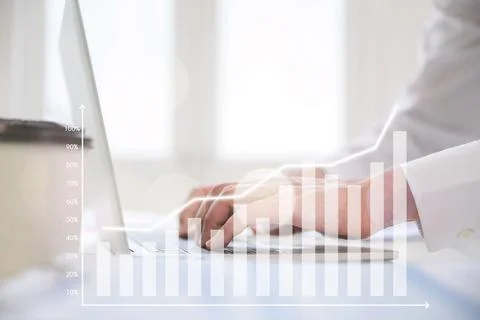 Hand using computer laptop analyzing sales data and economic growth graph cha Stock Photos