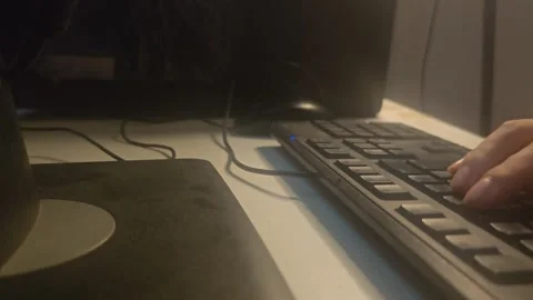 Hand using computer mouse and typing on keyboard in dark room 스톡 동영상 346546864