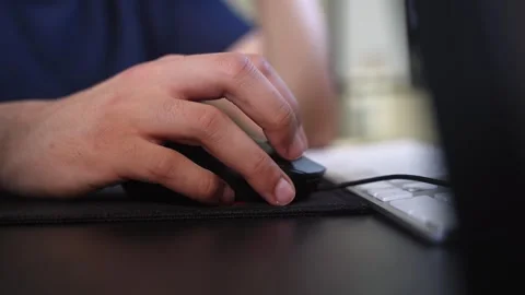 Hand Using Computer Mouse Beside Keyboard on Modern Office Desk Stock Footage 333854649