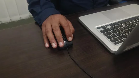 Hand Using Computer Mouse Beside Laptop on Office Desk Stock Footage 337913480