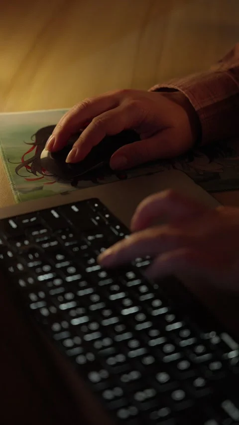 Hand Using Computer Mouse Beside Laptop in Warm Home Workspace Stock Footage 344950557