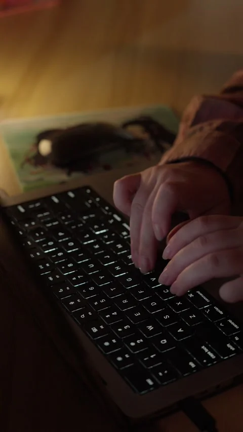 Hand Using Computer Mouse Beside Laptop in Warm Home Workspace Stock Footage 344950640