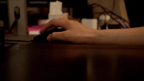 Hand Using Computer Mouse on Dark Desk Workspace 库存影片 334647629