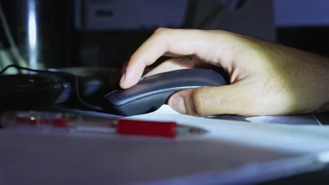 Hand Using Computer Mouse on Desk with Pen and Paper in Low Light Stock Footage 334076348