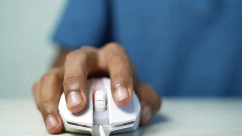 Hand using a computer mouse at desk, Close-up of a person using a white com.. Video stock 345119739