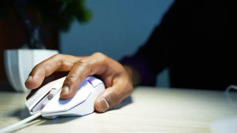 Hand using a computer mouse at a desk, Close-up of a hand using a white com.. Video stock 346462754