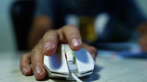Hand using a computer mouse at desk, Close-up of a hand using a white compu.. Stock Footage 347858398