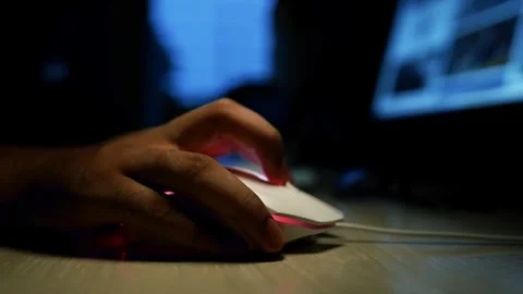 Hand Using Computer Mouse in Dimly Lit Room Stock Footage 320724238