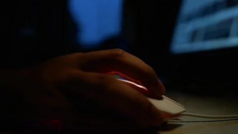 Hand Using Computer Mouse in Dimly Lit Room Stock Footage 320724244