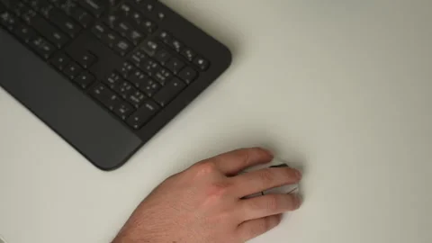 Hand using computer mouse with keyboard on desk Stock Footage 316233673