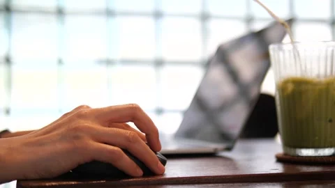 Hand Using Computer Mouse with Laptop and Green Smoothie on Modern Desk Video stock 325237396