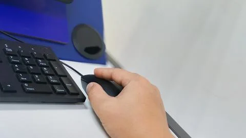 Hand Using a Computer Mouse Next to a Numeric Keypad Emphasizing Efficiency.. Stock Photos