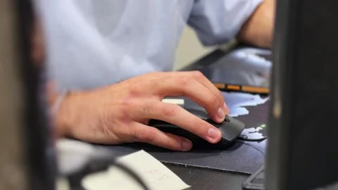 Hand using computer mouse at office desk in focused indoor workspace Stock Footage 333157904