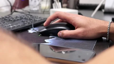 Hand Using Computer Mouse at Office Desk with Keyboard and Smartphone Nearby Stock Footage 333443596